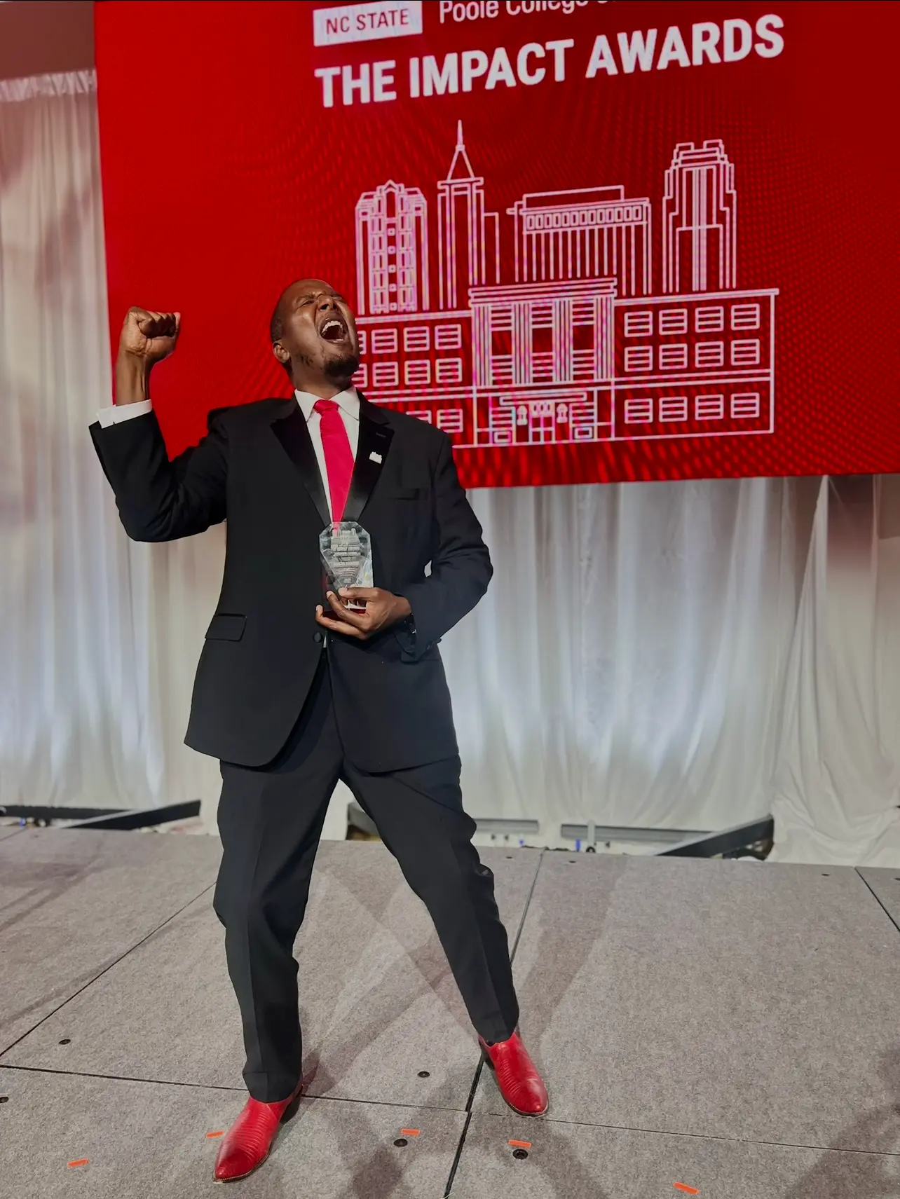 Marcus O. Rountree celebrating his Emerging Leader Award at the NC State Poole College Impact Awards.